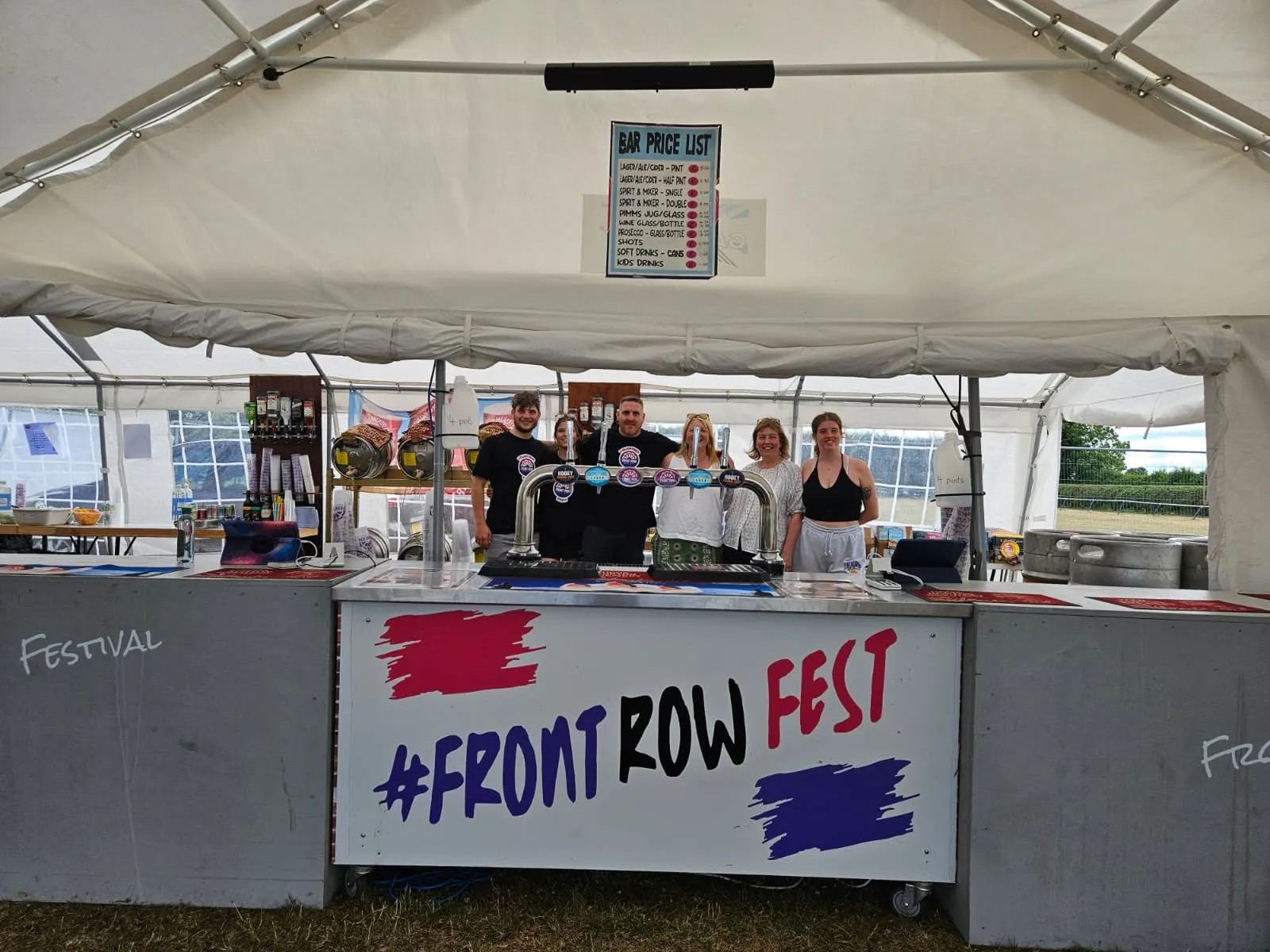 The Front Row Fest bar team serving drinks under the marquee